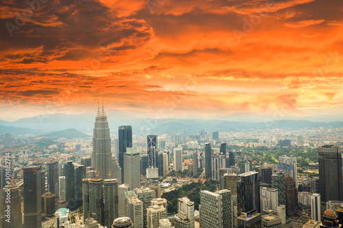 Kuala Lumpur city landscape view of skyline top view cityscape at Malaysia Asian / Red cloud orange on the city global warming storm sky dramatic dust in the city smoke © Bigc Studio