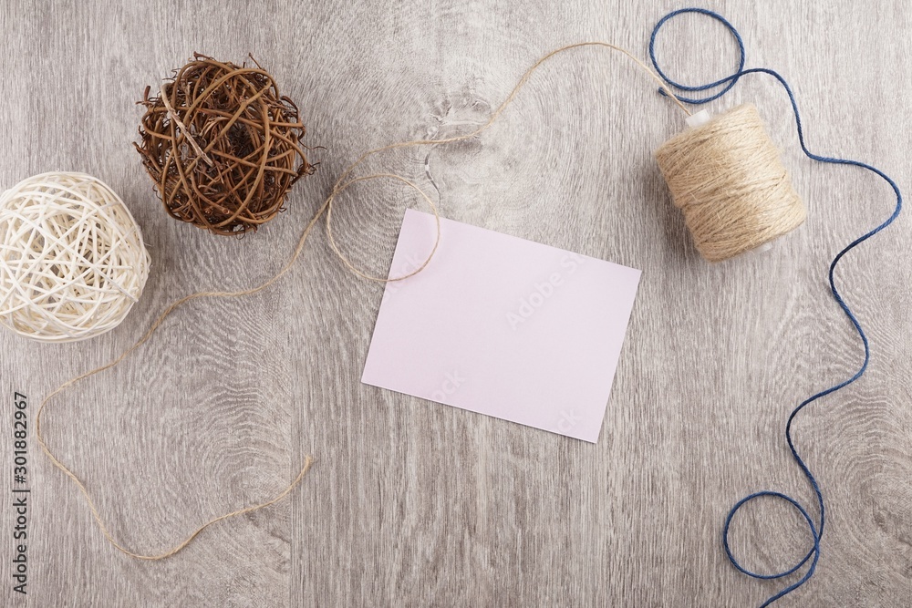 twine and two decorative balls, burlap and coffee mug on light gray wooden background. Space for text twine and two decorative balls, burlap and coffee mug on light gray wooden background. Space for text