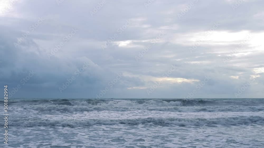 Sea waves with foam in cloudy rainy day slow motion Sea waves with foam in cloudy rainy day slow motion
