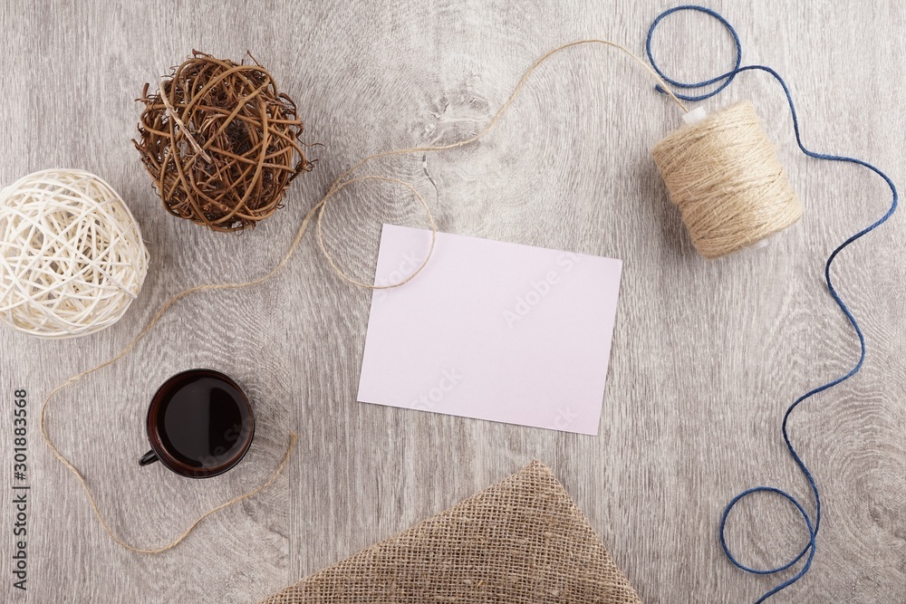 twine and two decorative balls, burlap and coffee mug on light gray wooden background. Space for text twine and two decorative balls, burlap and coffee mug on light gray wooden background. Space for text