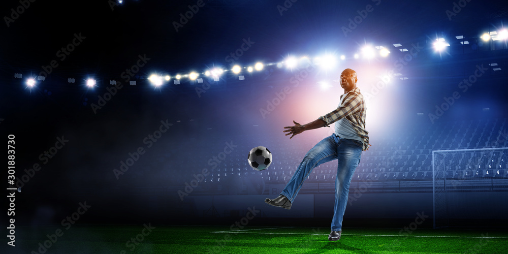 Soccer man in action with ball. Mixed media Soccer man in action with ball. Mixed media