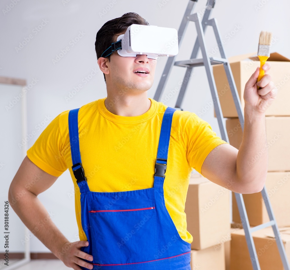 Painter contractor working with virtual reality goggles