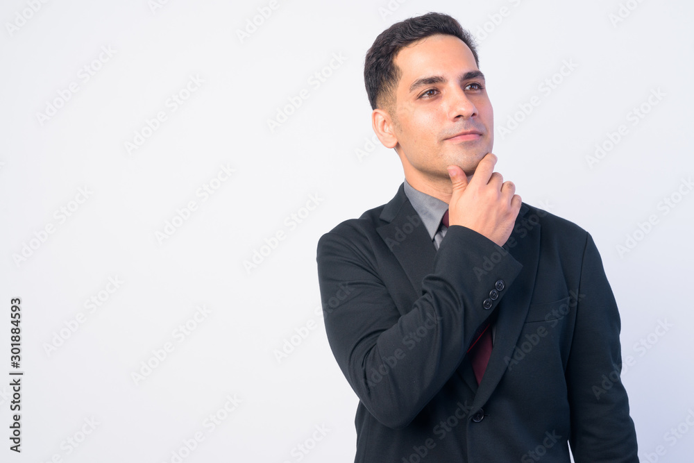 Portrait of handsome Persian businessman in suit thinking Portrait of handsome Persian businessman in suit thinking
