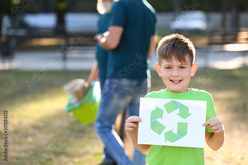 Boy holding paper sheet wit...