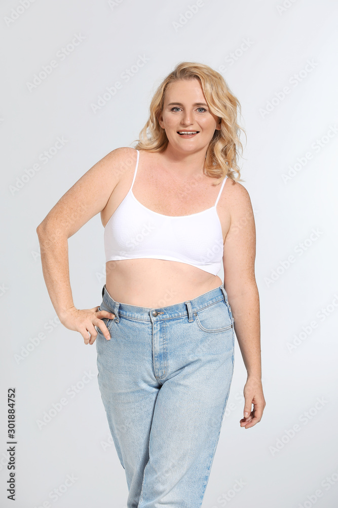 Mature body positive woman on grey background Mature body positive woman on grey background
