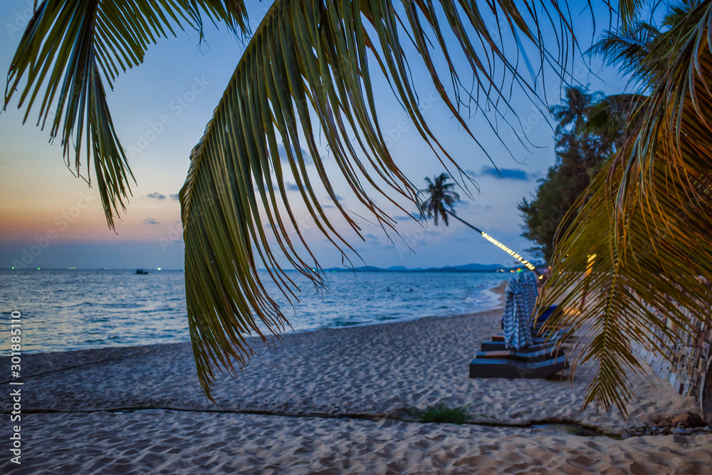 Phu Quoc island, Vietnam - March 30, 2019: Sandy beach with palm trees on the shore of the Indian Ocean at sunset.