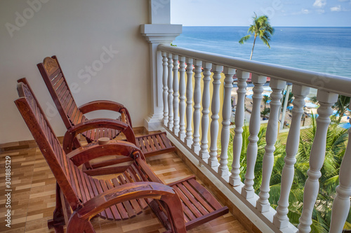 Obraz na płótnie Two lounge chairs on the terrace overlooking the ocean and the beach, Phu Quoc island, Vietnam w salonie