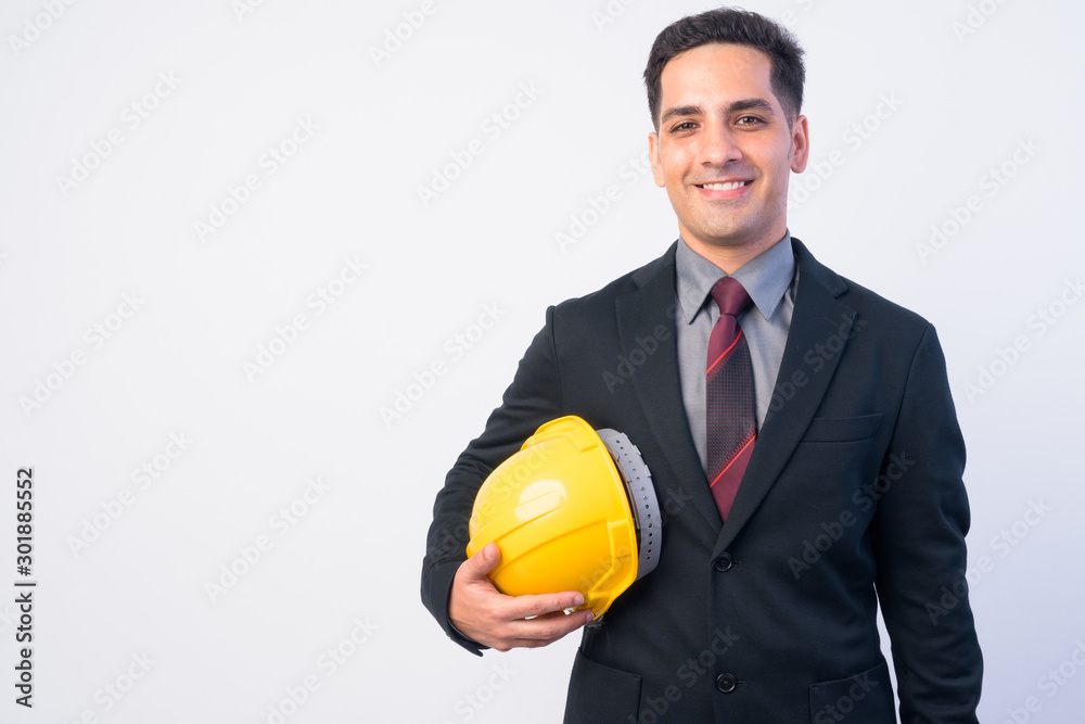 Portrait of happy Persian businessman as engineer smiling Portrait of happy Persian businessman as engineer smiling