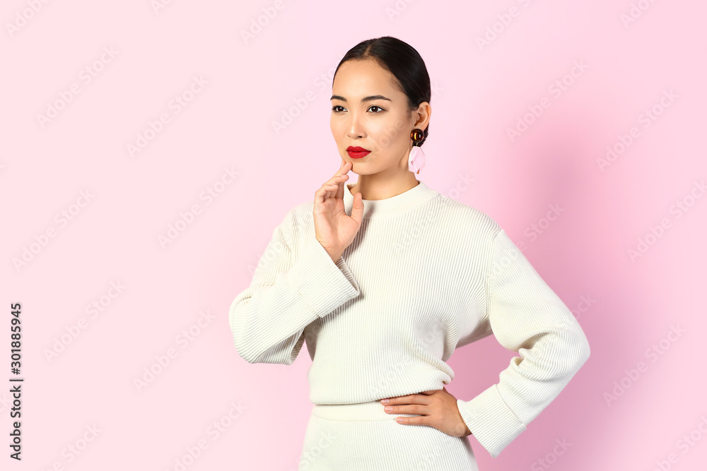 Fashionable Asian woman on color background Fashionable Asian woman on color background