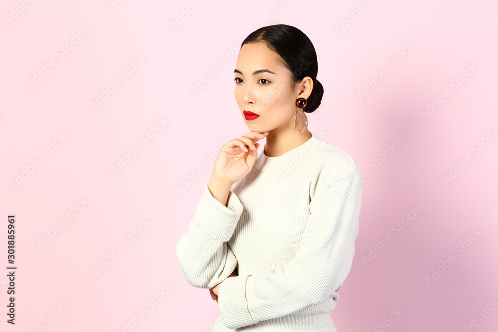 Fashionable Asian woman on color background Fashionable Asian woman on color background