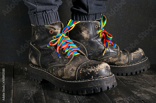 Brutal black boots with rainbow colored laces photo