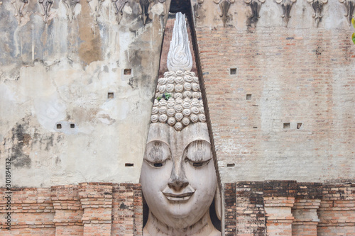 The ancient Phra Ajana Buddha image statue at Srichum temple in the old historical park in Sukhothai province , Thailand. photo