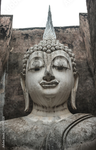 The ancient Phra Ajana Buddha image statue at Srichum temple in the old historical park in Sukhothai province , Thailand. photo