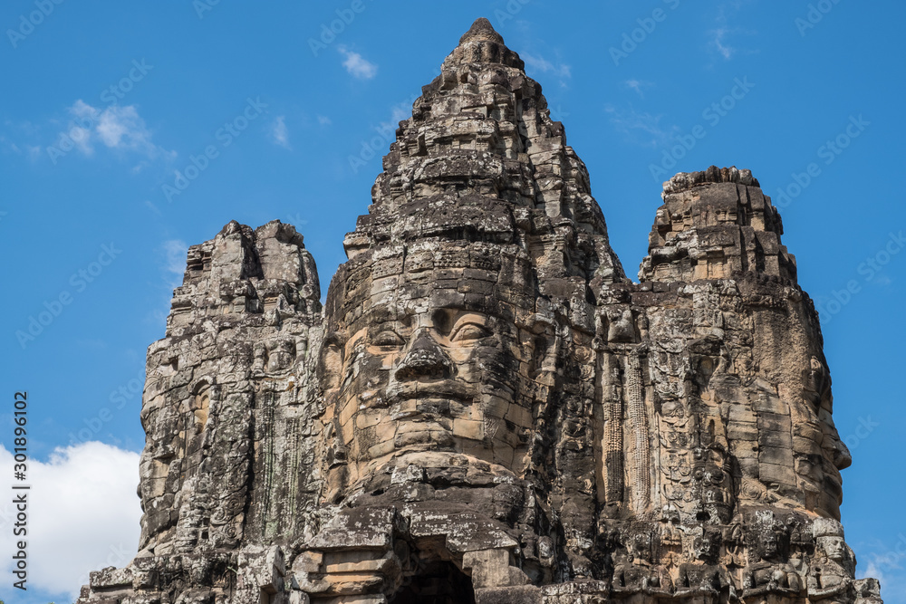 The face tower on the south gate to Angkor Thom the ancient capital city of Khmer empire in Siem Reap, Cambodia.