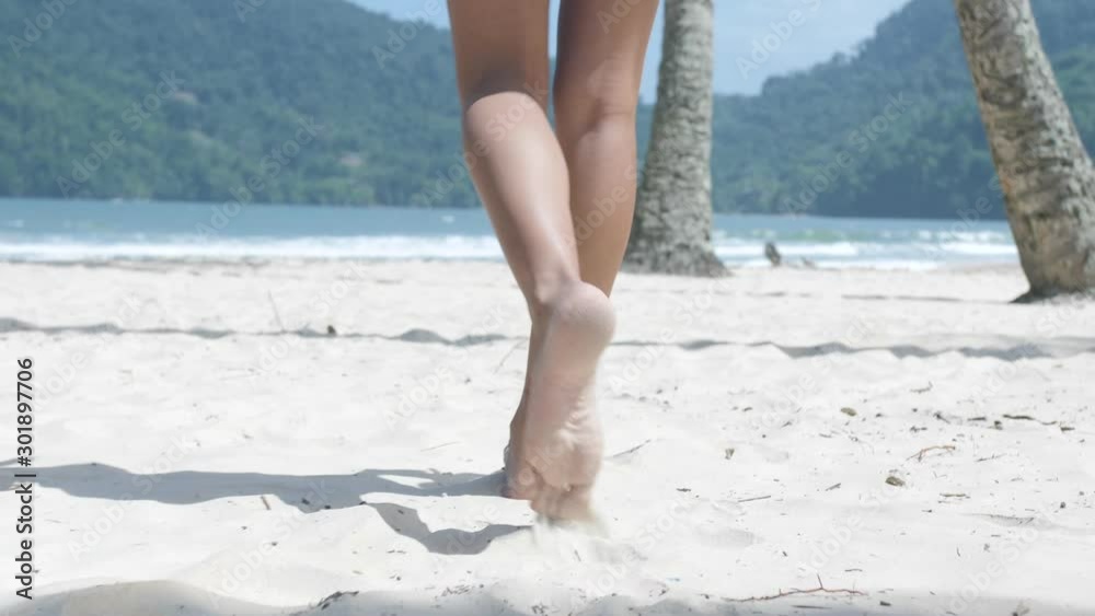 Girl walking on the beach in slow motion Girl walking on the beach in slow motion