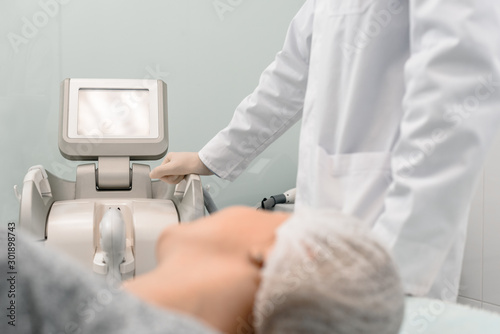 Woman during procedure of facial skin microdermabrasion in beauty salon