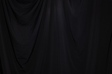 Black Curtain drape wave with studio lighting, Wallpaper Background Texture Detail of light and shadow, stage opening screen for performance and music