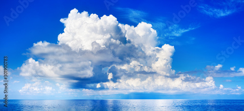 White cumulus clouds in blue sky over sea landscape, big cloud above ocean water panorama, horizon, beautiful tropical sunny summer day seascape panoramic view, cloudy weather, cloudscape, copy space