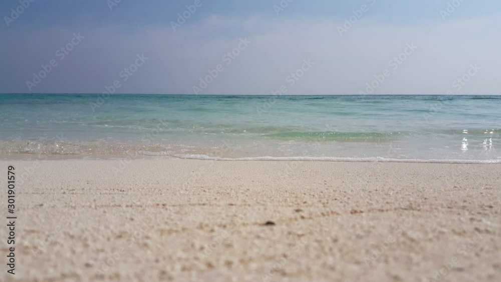 Tripod low angle shot of the waves softly touching the sand in Bermuda Tripod low angle shot of the waves softly touching the sand in Bermuda