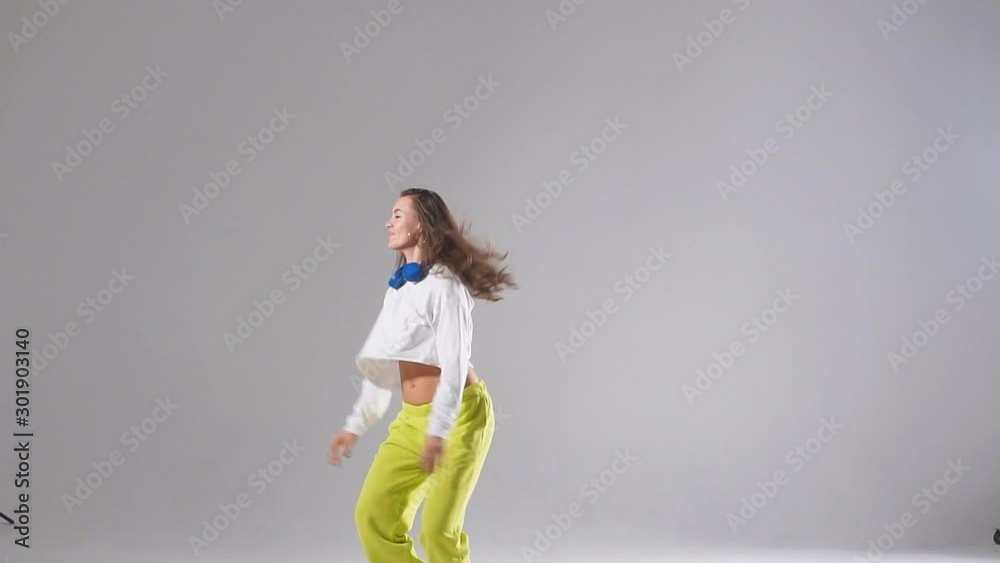 High jump of charming female dancer doing split leap in the air, performing modern dance element High jump of charming female dancer doing split leap in the air, performing modern dance element