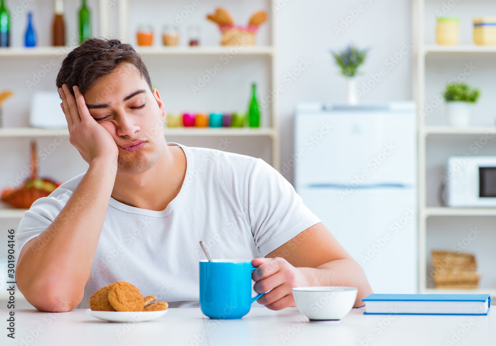Man falling asleep during his breakfast after overtime work Man falling asleep during his breakfast after overtime work