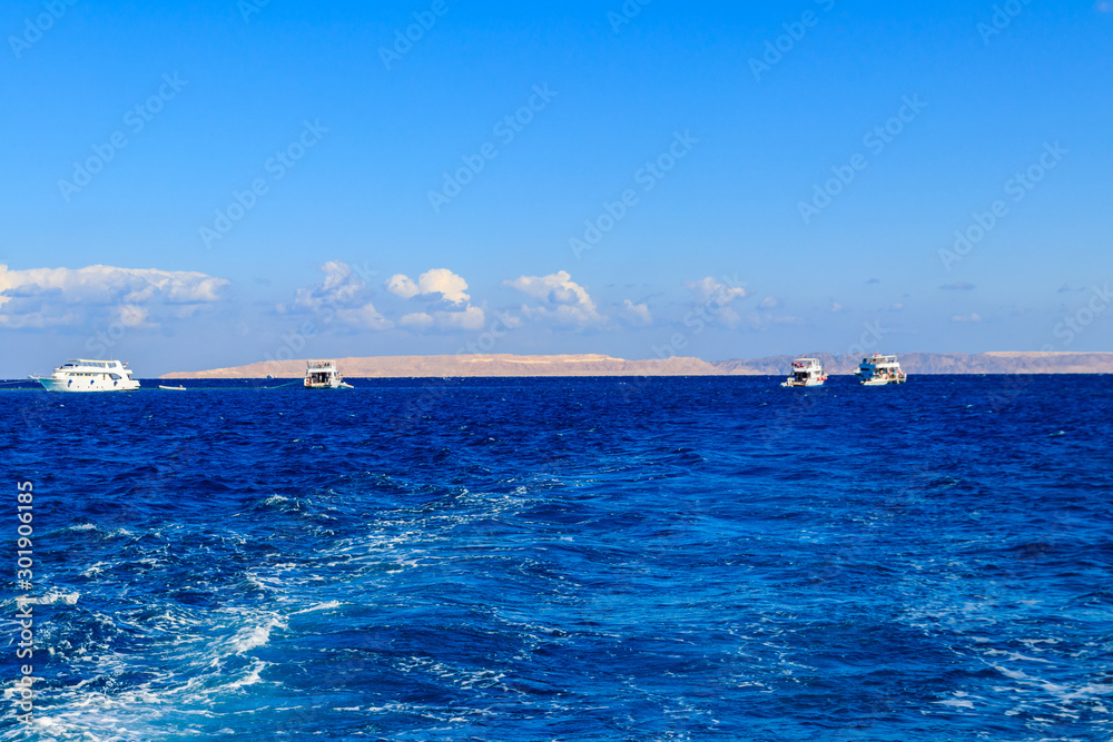 View of Red sea and white yachts on horizon near Hurghada, Egypt