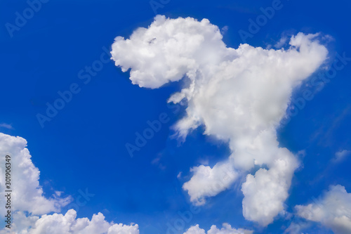 Fototapeta Naklejka Na Ścianę i Meble -  Animal cloud, Fresh blue sky with floated white soft and fluffy cloudy shown shaping like a dinosaur name Tyrannosaurus Rex was walking, Background for kid education or imagination learning for Child.