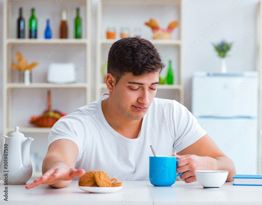 Man falling asleep during his breakfast after overtime work Man falling asleep during his breakfast after overtime work