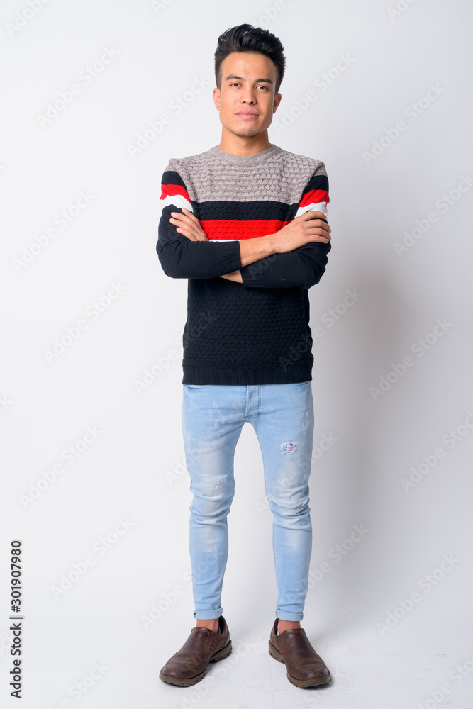 Full body shot of young Asian man with arms crossed Full body shot of young Asian man with arms crossed
