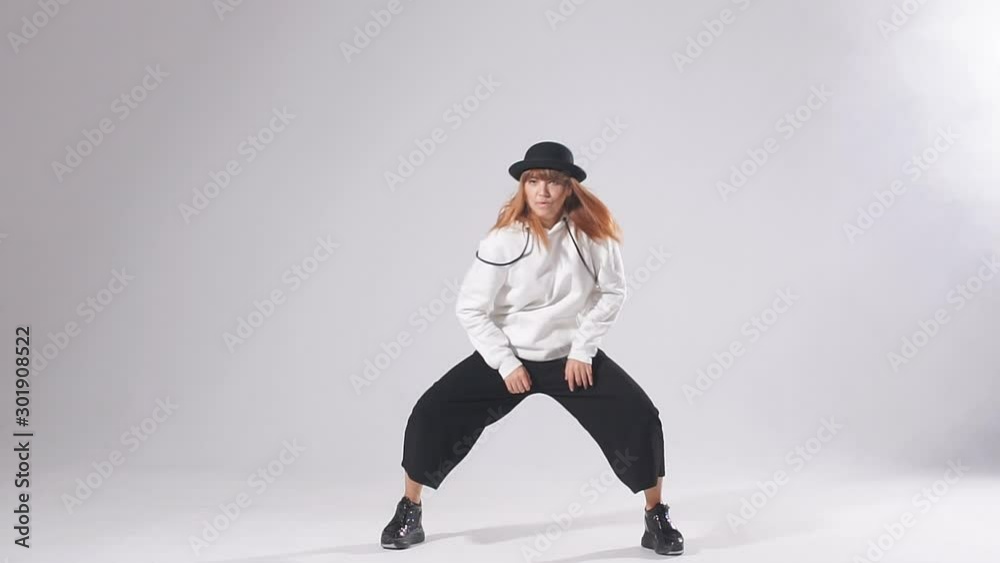 Funk dance workout. Portrait of young sporty woman in motion performing dance element. Funk dance workout. Portrait of young sporty woman in motion performing dance element.