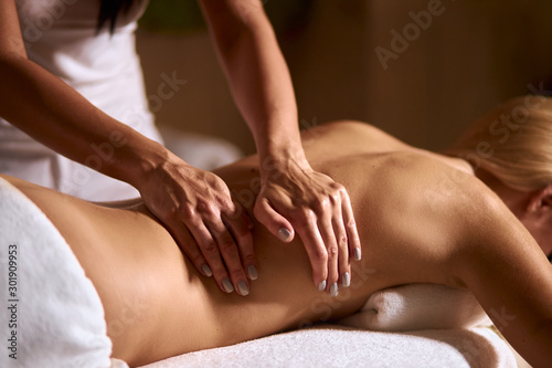 Obraz na plátně Young blonde woman in wellness beauty spa having aroma therapy massage with esse