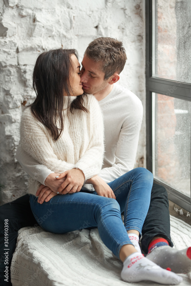 Loving couple on a light background on the windowsill. Love, cares, warmth. Loving couple on a light background on the windowsill. Love, cares, warmth.