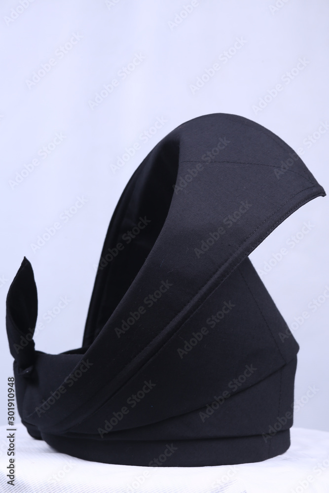 A Malay black coloured with gold lace traditional