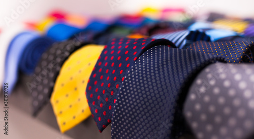 Fotografering row of Neckties on hangers in men clothing store