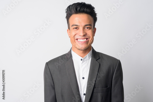 Face of happy young Asian businessman in suit smiling