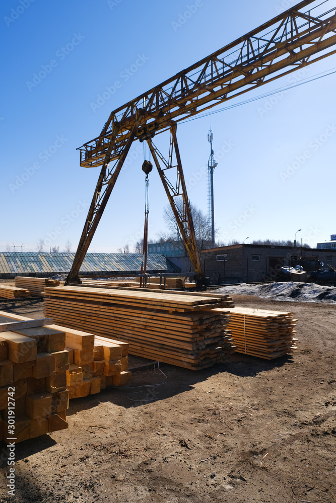 Fototapeta premium Wood timber in the sawmill. Piles of wooden boards in the sawmill.