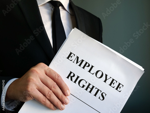 Employee rights law papers in the hands.