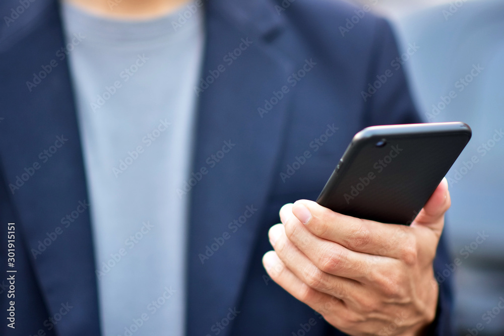 Businessman holding cell phone using Mobile phone or Smart phone Telephone to call phone with Social media Icon technology by WiFi internet Network digital Businessman holding cell phone using Mobile phone or Smart phone Telephone to call phone with Social media Icon technology by WiFi internet Network digital