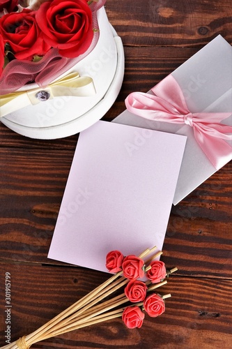Gift box with flowers on wooden background  preparation for the holiday concept. Top view and copy area for text.