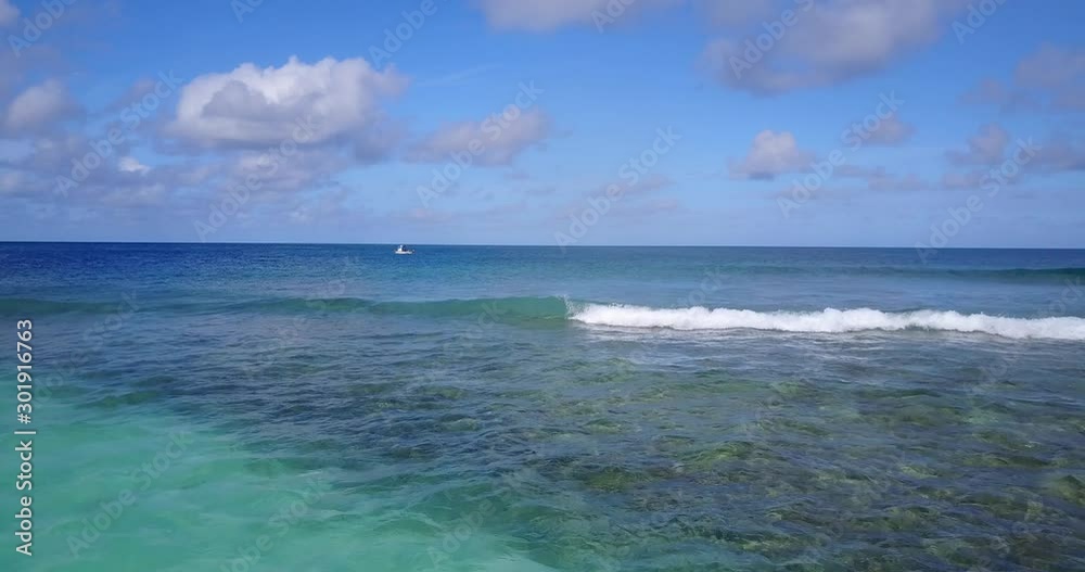 beach with turquoise waters and waves creating foam on the water surface in Australia - Slow forward moving shot beach with turquoise waters and waves creating foam on the water surface in Australia - Slow forward moving shot