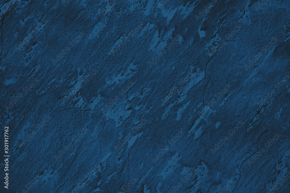 Fototapeta premium Dark blue colored low contrast stone textured background with roughness and irregularities to your design or product. Color trend concept.