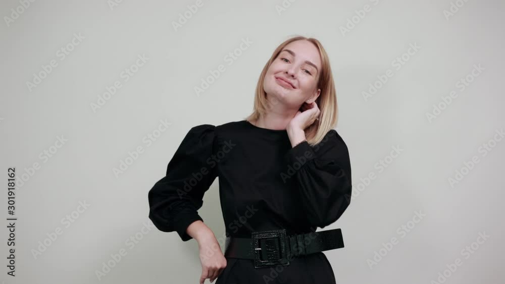 Pretty smiling young woman in casual clothes looking camera, put hands prop up on chin isolated on white wall background. People sincere emotions, lifestyle concept.