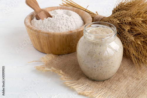 Active rye sourdough in a glass jar for homemade bread.