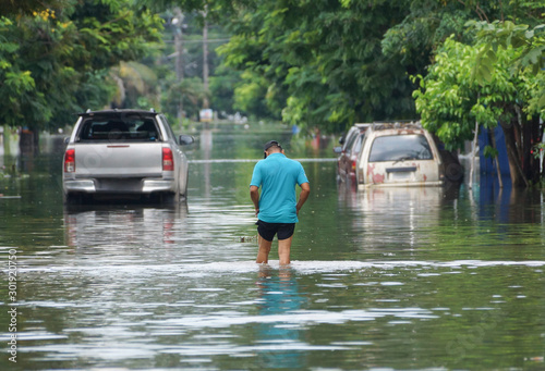 Fotografie, Tablou Man walking on a flooded road