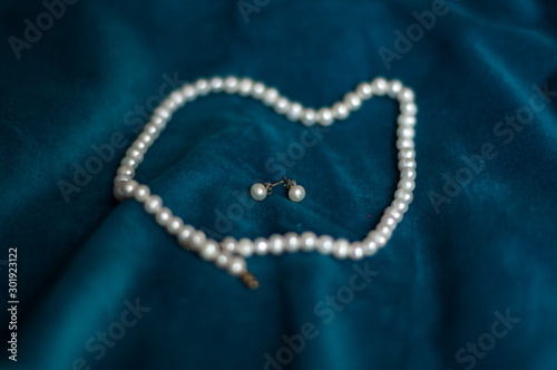 pearl necklace on blue background