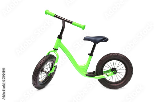A green balance bike isolated on white background