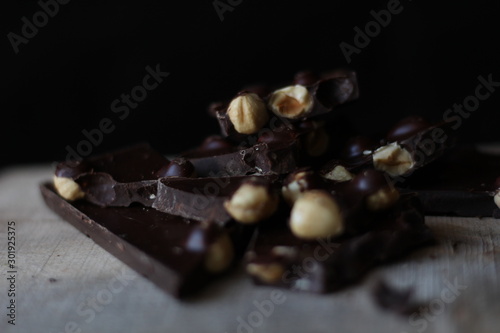 broken pieces of black chocolate with nuts