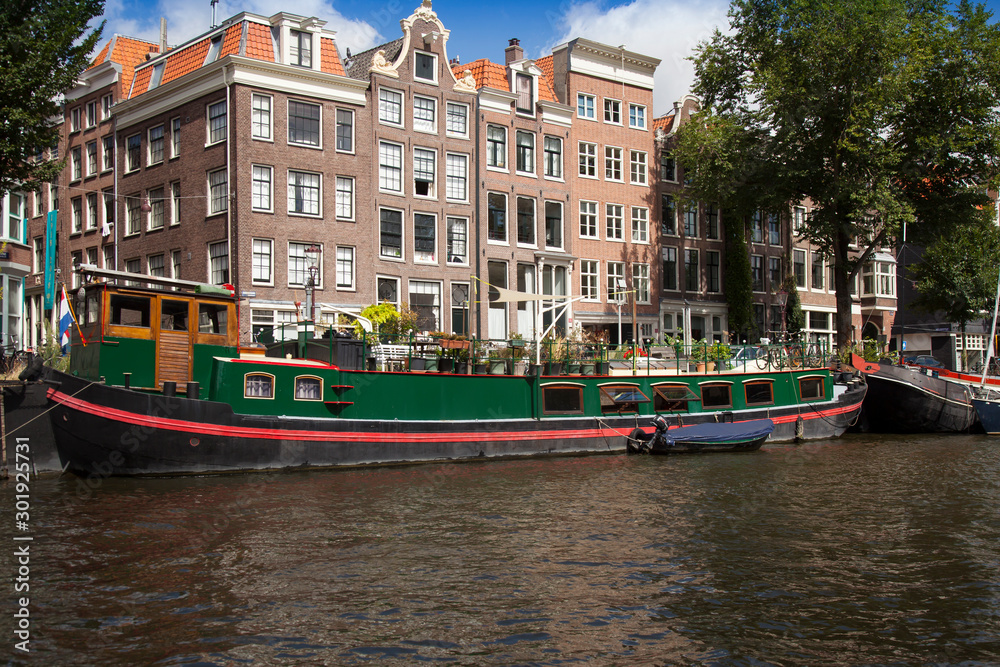 Typical houseboats in front of half-timbered houses in Herrengracht, Amsterdam, Holland, Netherlands