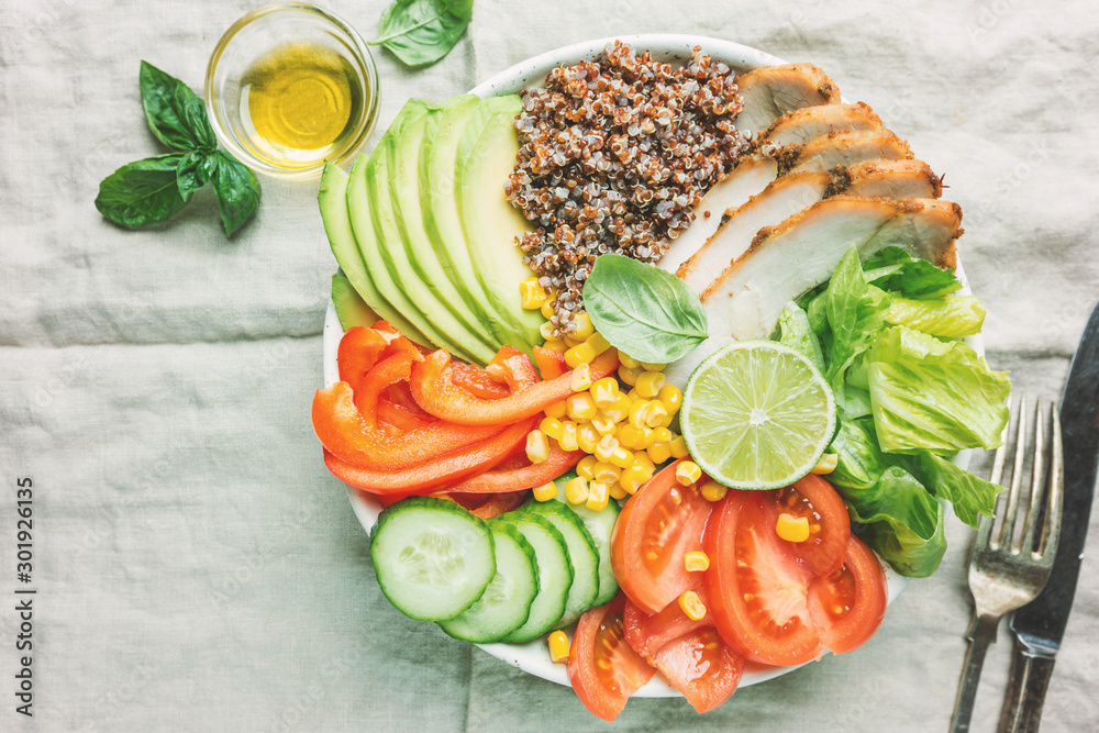 Healthy salad bowl with quinoa, tomato turkey, avocado, sweet pepper, corn, lime and mixed greens, top view. Healthy food conception. Superfood meal. Healthy salad bowl with quinoa, tomato turkey, avocado, sweet pepper, corn, lime and mixed greens, top view. Healthy food conception. Superfood meal.