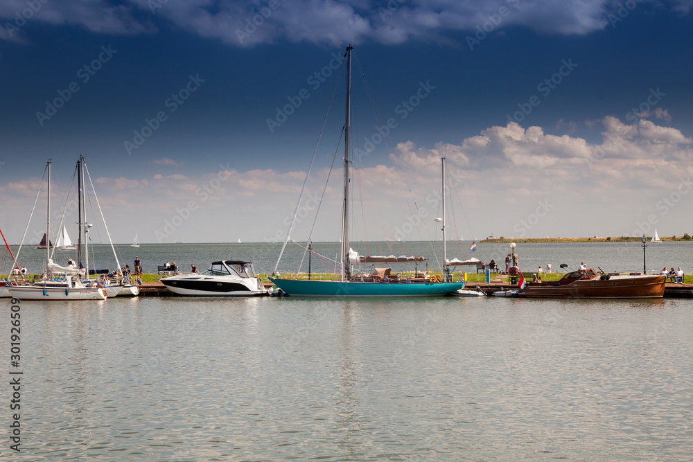 Boats at the harbor entrance of the small harbor of Volendam, Markermeer, Holland, Netherlands